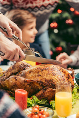 man cutting christmas turkey