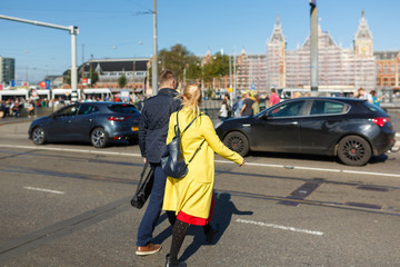 Young couple is crossing the road in wrong place, Amsterdam