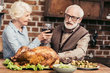 senior couple drinking wine on thanksgiving