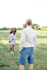 A loving couple is walking around the fields. Warm autumn. Summer. Spring. Happy couple. Wedding. Love.