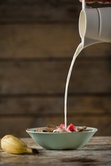 Milk being poured in wheat flakes