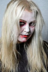 zombie girl with black eyes and a bloody mouth on Halloween