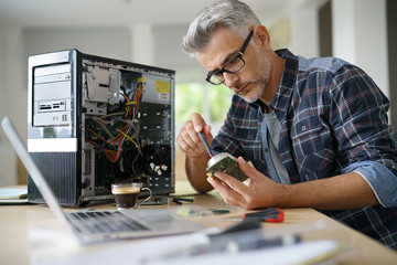 Technician repairing computer hardware