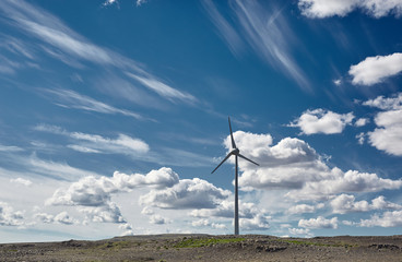 Windmill for electric power production. Wind generator turbine and blue sky with clouds in Iceland- ecology energy saving concept