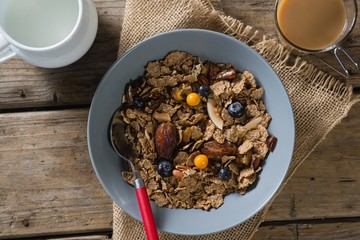 Bowl of wheat flakes with blueberry and golden berry