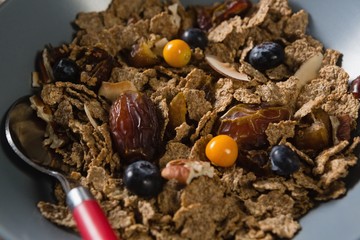 Wheat flakes with blueberry and golden berry in bowl