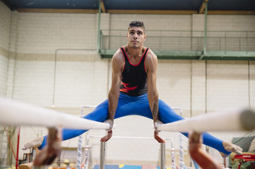 Male gymnast performing on gymnastic rings