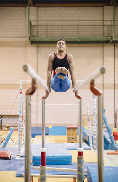 Male gymnast performing on gymnastic rings