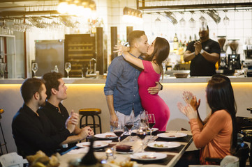 Proposal in the restaurant with a man asking marry to his happy girlfriend
