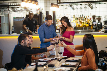Proposal in the restaurant with a man asking marry to his happy girlfriend