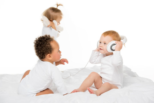 multiethnic toddlers with headphones