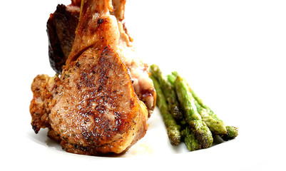grilled lamb steak with asparagus on a white plate