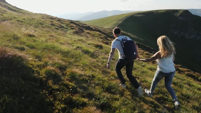 Couple running on the mountain range.
