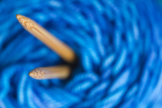 Macro of wooden knitting needles in spool of yarn