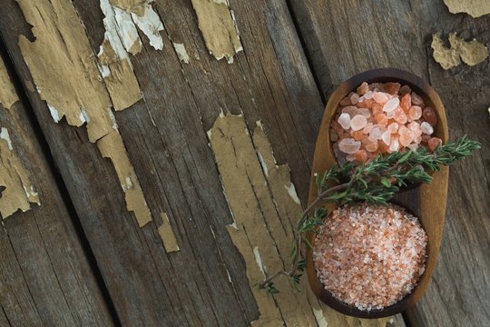 Himalayan salt with rosemary in wooden bowl