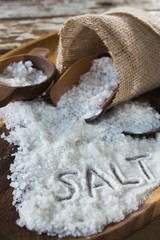 Word salt on wooden plate