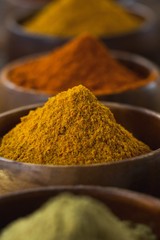 Various spice powder on wooden table