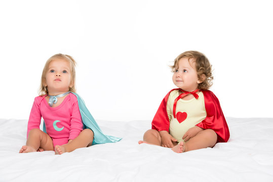toddler girls in superhero capes