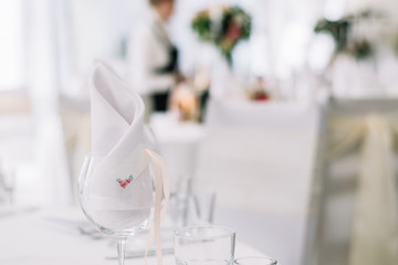 Close up of glass and name card. Table setting at wedding. Card for the name of the guest at engagement party