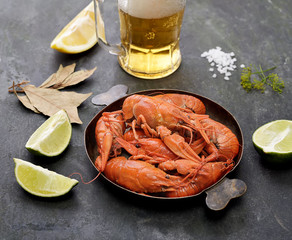 boiled crawfish in a plate on a black background