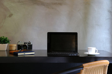 Laptop On the desk In office at home style loft cement wall in background