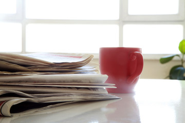 Newspaper with coffee on table