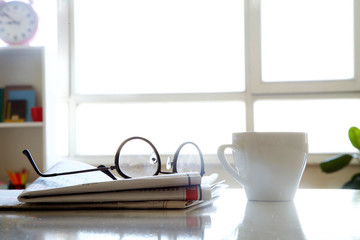Newspaper with coffee on table