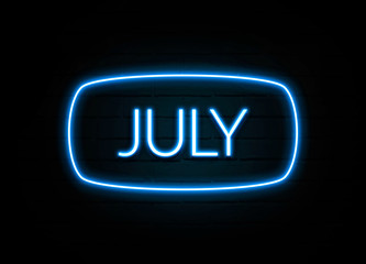 July  - colorful Neon Sign on brickwall