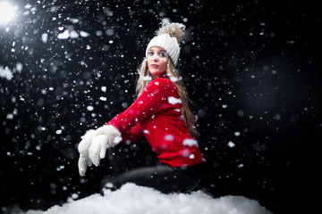 Naklejka na ściany i meble Girl in red jumper posing in snow