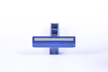 Blue shaving stick, razor blade closeup isolated on white background 