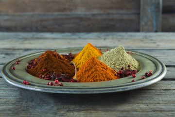 Various type of spices in plate on wooden table