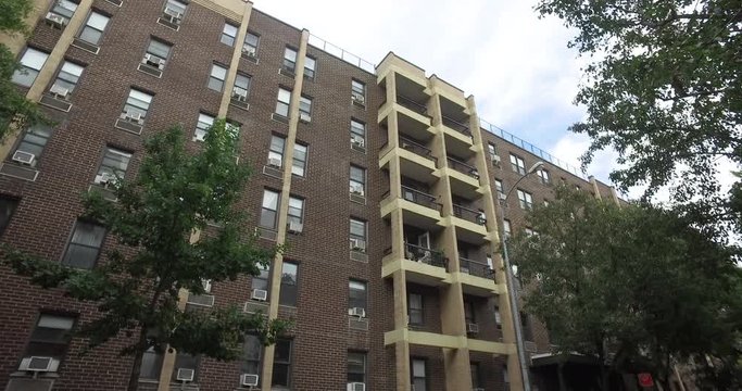Exterior large apartment building establishing shot in New York City. Affordable housing complex or middle class income family real estate rental. 4k DX stock video