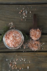 Himalayan salt and rosemary on wooden table