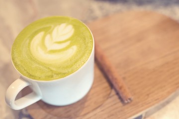 Green tea, Matcha latte milk in a cup on the wooden table