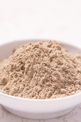 Cosmetic clay powder in the plastic container