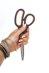 Scissors in woman hand on white background