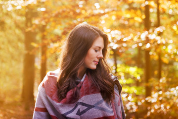 beautiful young woman outside in autumn sun