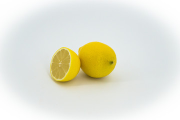Group of ripe whole yellow lemon citrus fruit with lemon fruit half