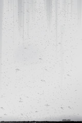 Grey wall with potholes and cracks