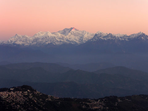 First rays of sun hit the peak of Mt. Kanchenjunga