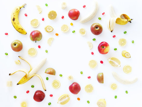 Composition of bananas, lemons and apples on a white background, flat layout, top view. Fruit background. Pattern of fruits.Food frame.