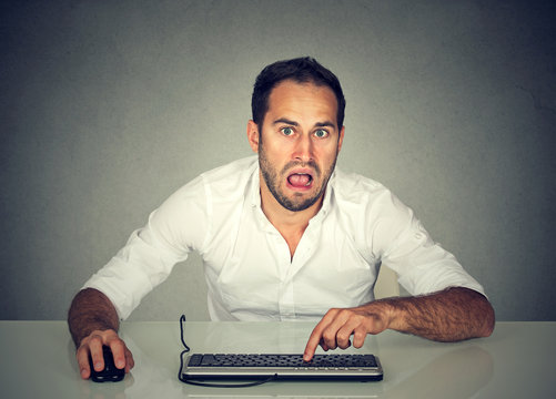 Confused upset man working on computer