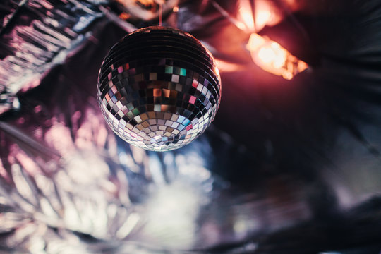 Disco ball hanging from the ceiling of a house party