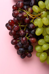 Fresh grapes on pink
