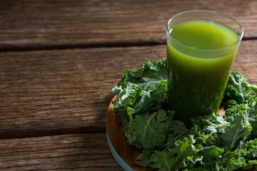 Mustard greens and juice on wooden board