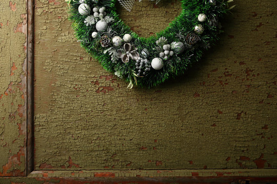 Green Christmas wreath on green door