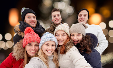 happy friends taking selfie outdoors at christmas