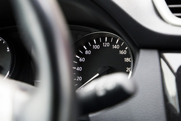 modern speedometer on a black dashboard