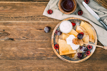 russian pancakes and ingredients on wooden background