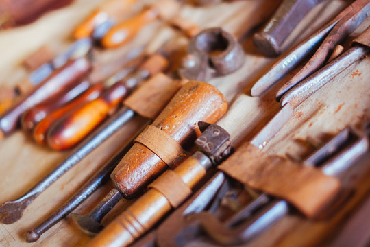 A collection of vintage leather working tools